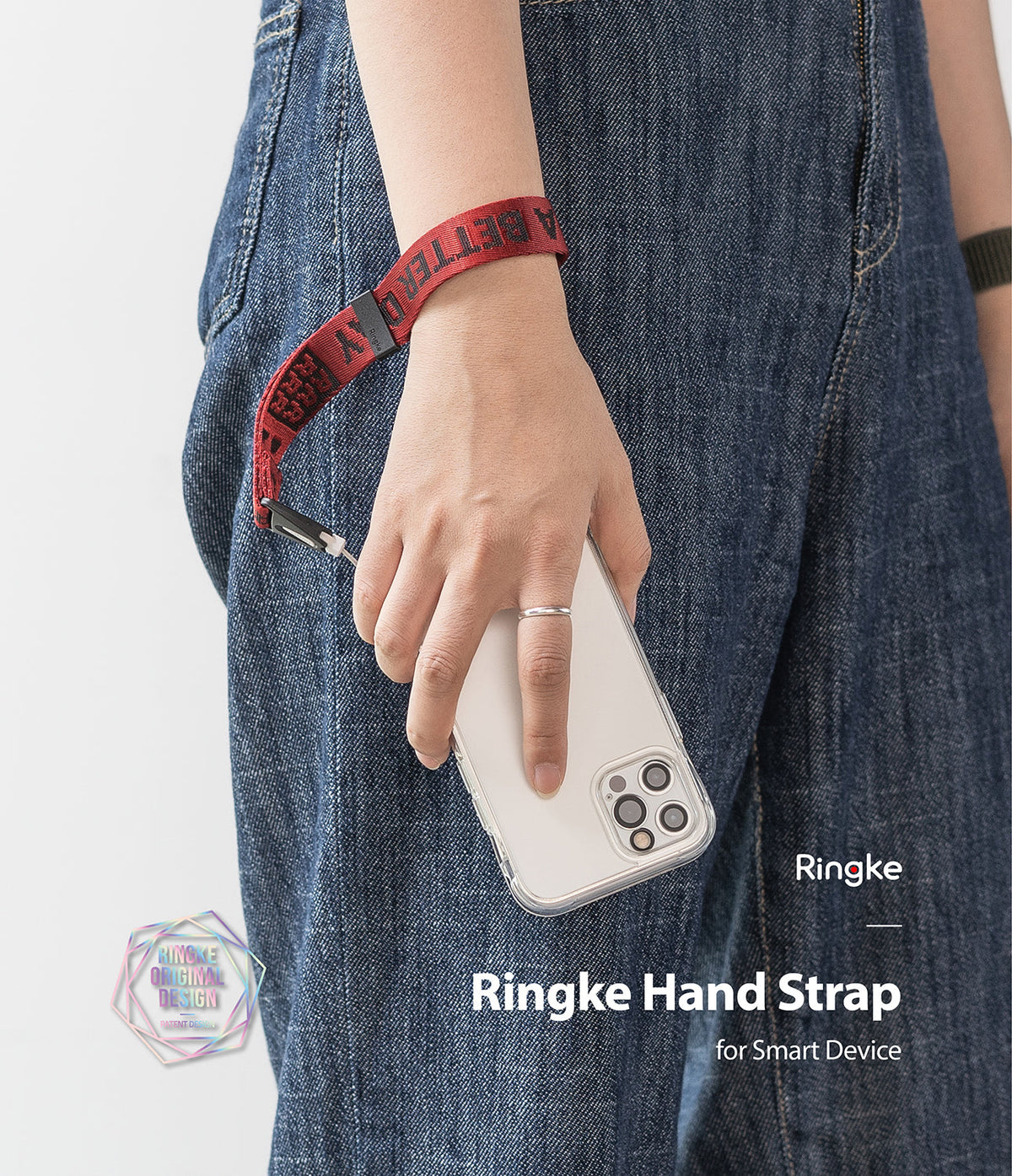 Hand Strap | Lettering - A person wearing a red fabric wrist strap with black lettering attached to a clear phone case.