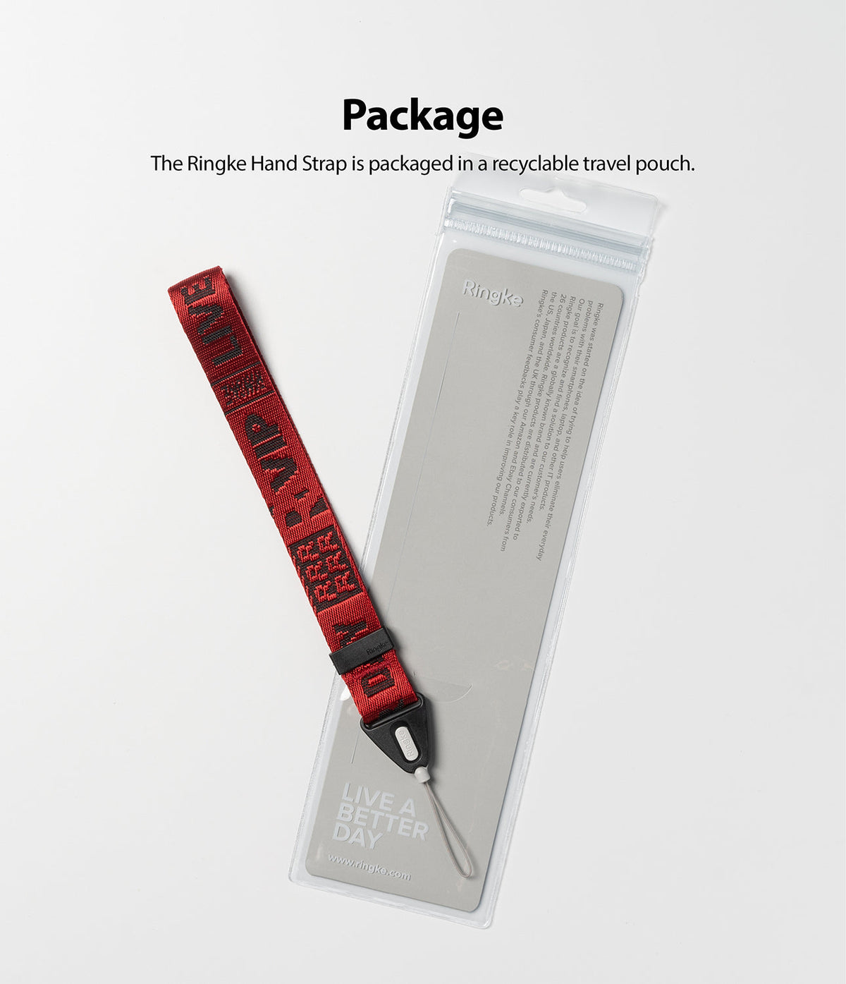 Hand Strap | Lettering - Red fabric hand strap with black lettering next to its clear, branded recyclable packaging pouch.