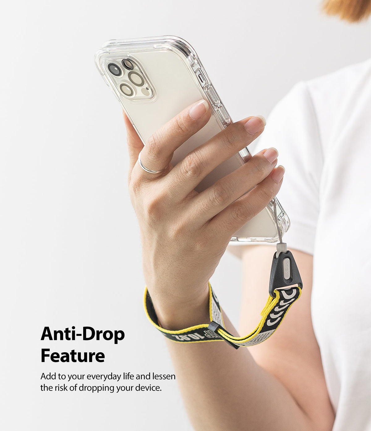 Hand Strap | Lettering - A person holding a phone with a yellow and black branded wrist strap for anti-drop security.