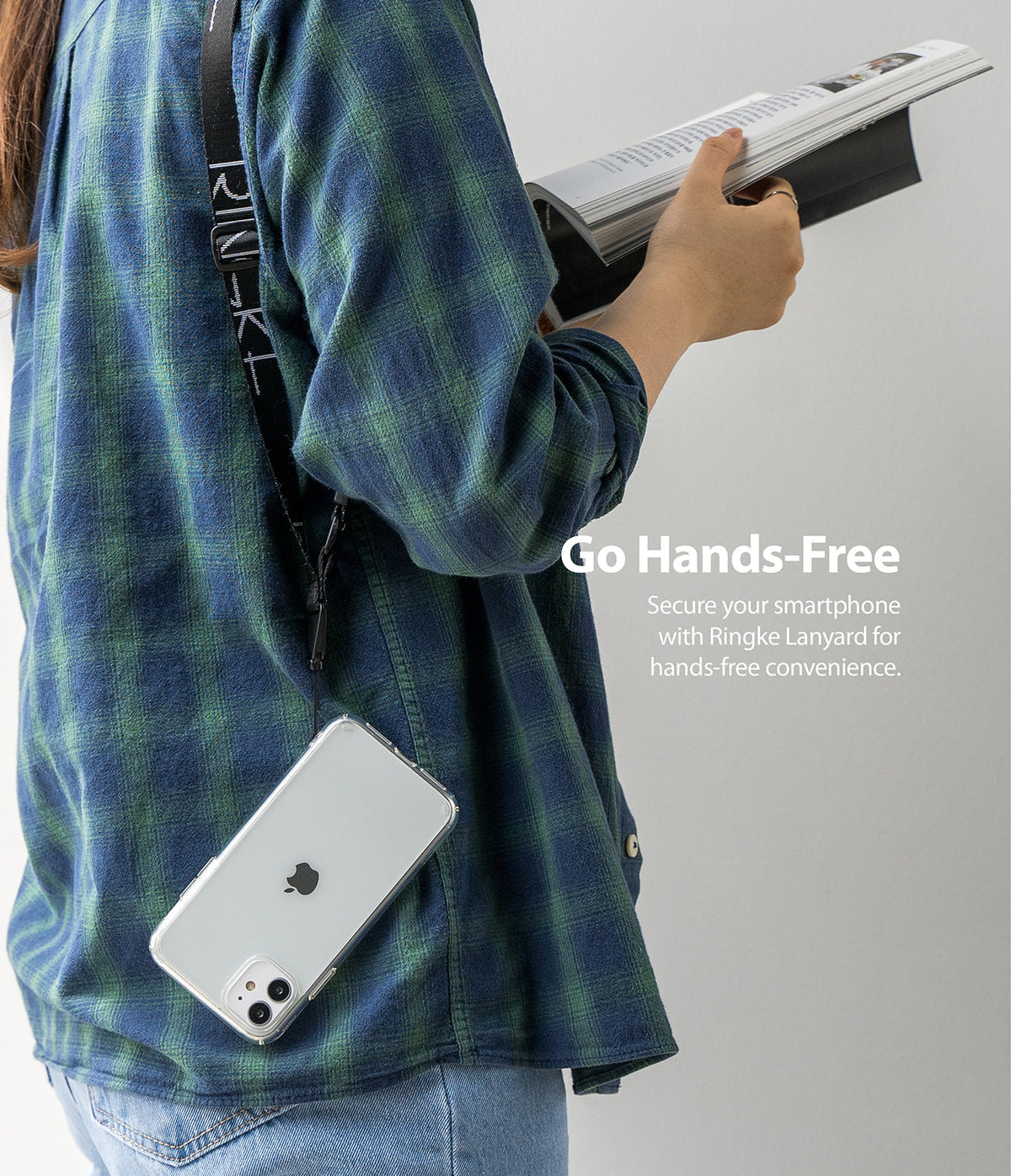 Design Lanyard Strap - Person wearing a black Ringke branded lanyard with a clear smartphone case hanging at their side.