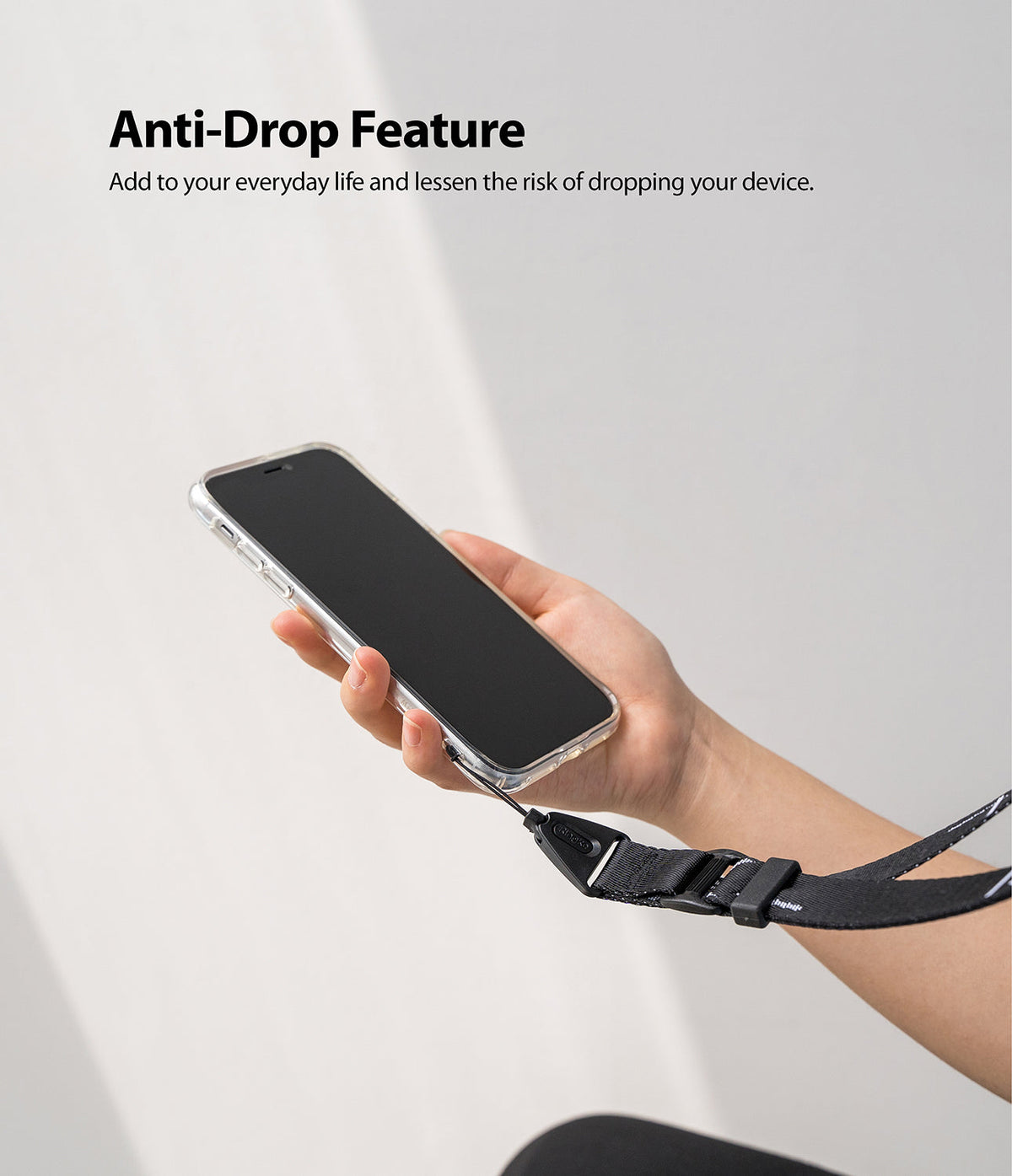Design Lanyard Strap - A hand holding a smartphone attached to a black, adjustable fabric lanyard for anti-drop security.