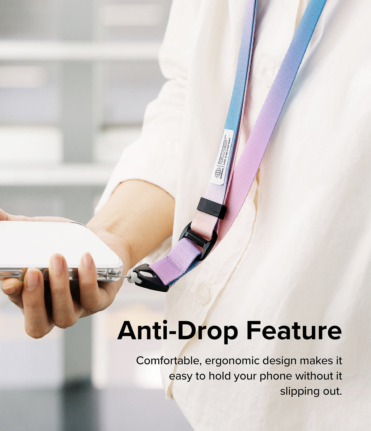 Design Lanyard Strap - A person wearing a pastel blue and purple phone lanyard attached to a smartphone for anti-drop security.