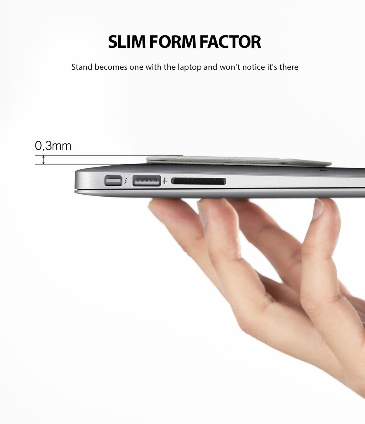 Laptop Stand - A hand holds a laptop with a 0.3mm slim gray adhesive stand attached to the bottom.
