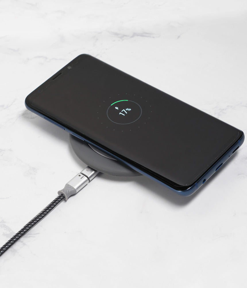 Micro USB to Type C Adapter - Smartphone charging on a wireless pad connected by a braided cable with a metal adapter.