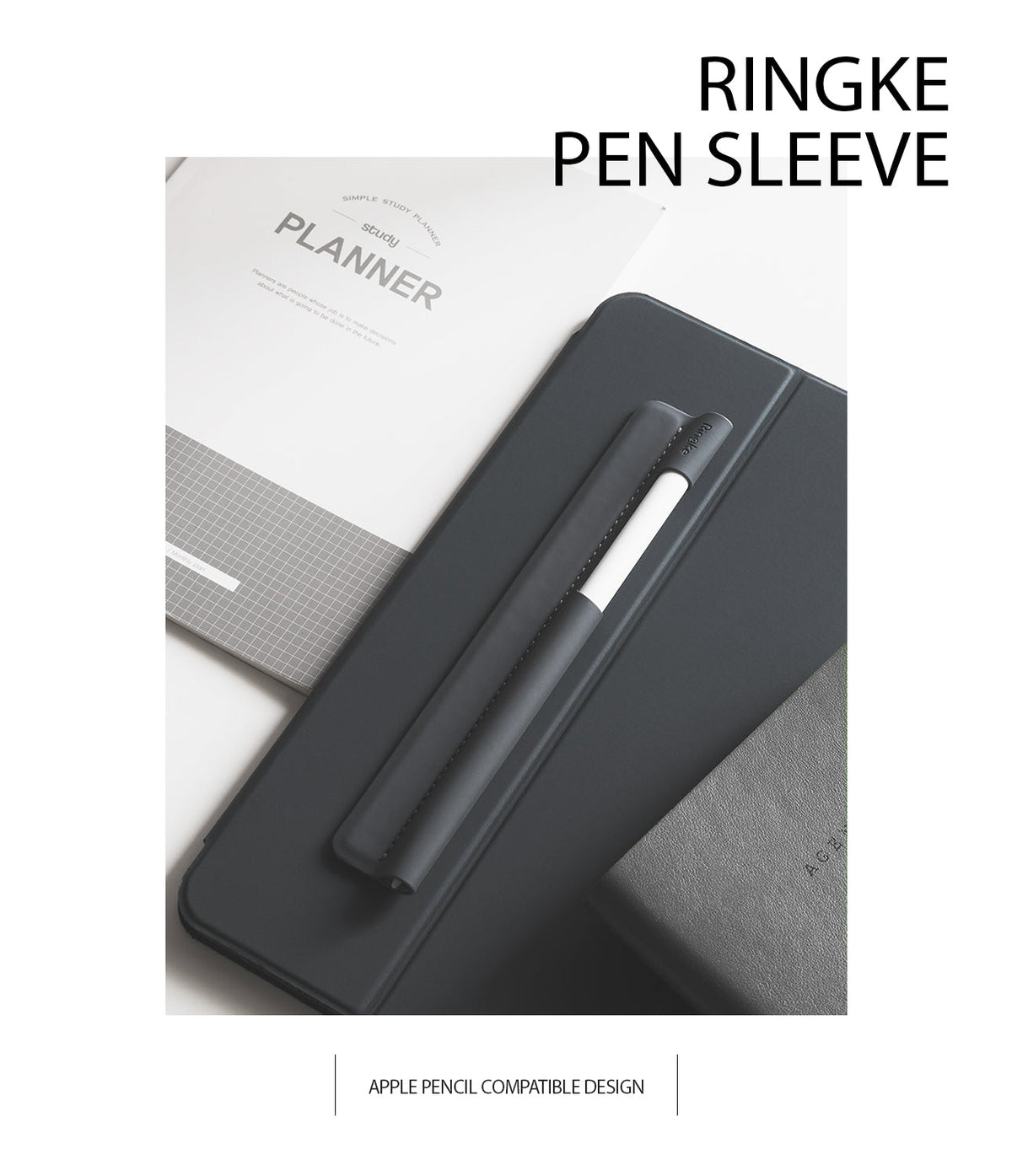 Pen Sleeve - A dark grey adhesive pen sleeve holding a white stylus on a tablet case next to a study planner.
