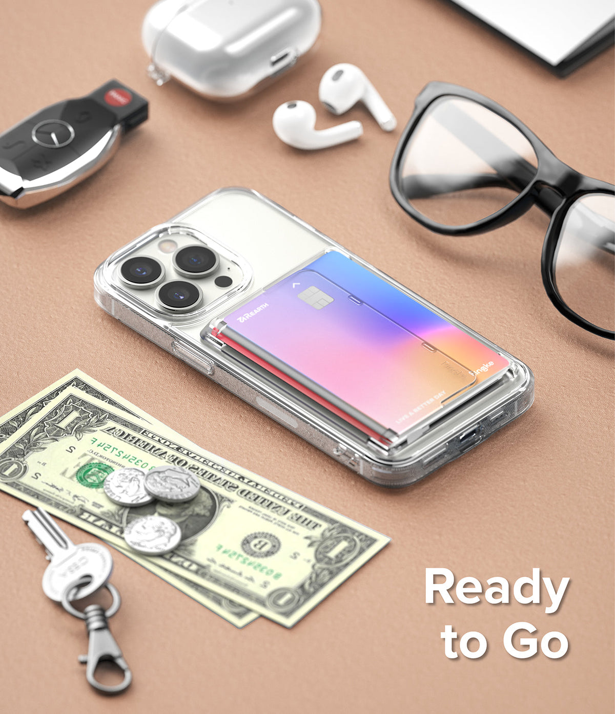 Card Holder | Side Slot - Clear phone case with a colorful card in a side slot, surrounded by everyday items on a tan surface.