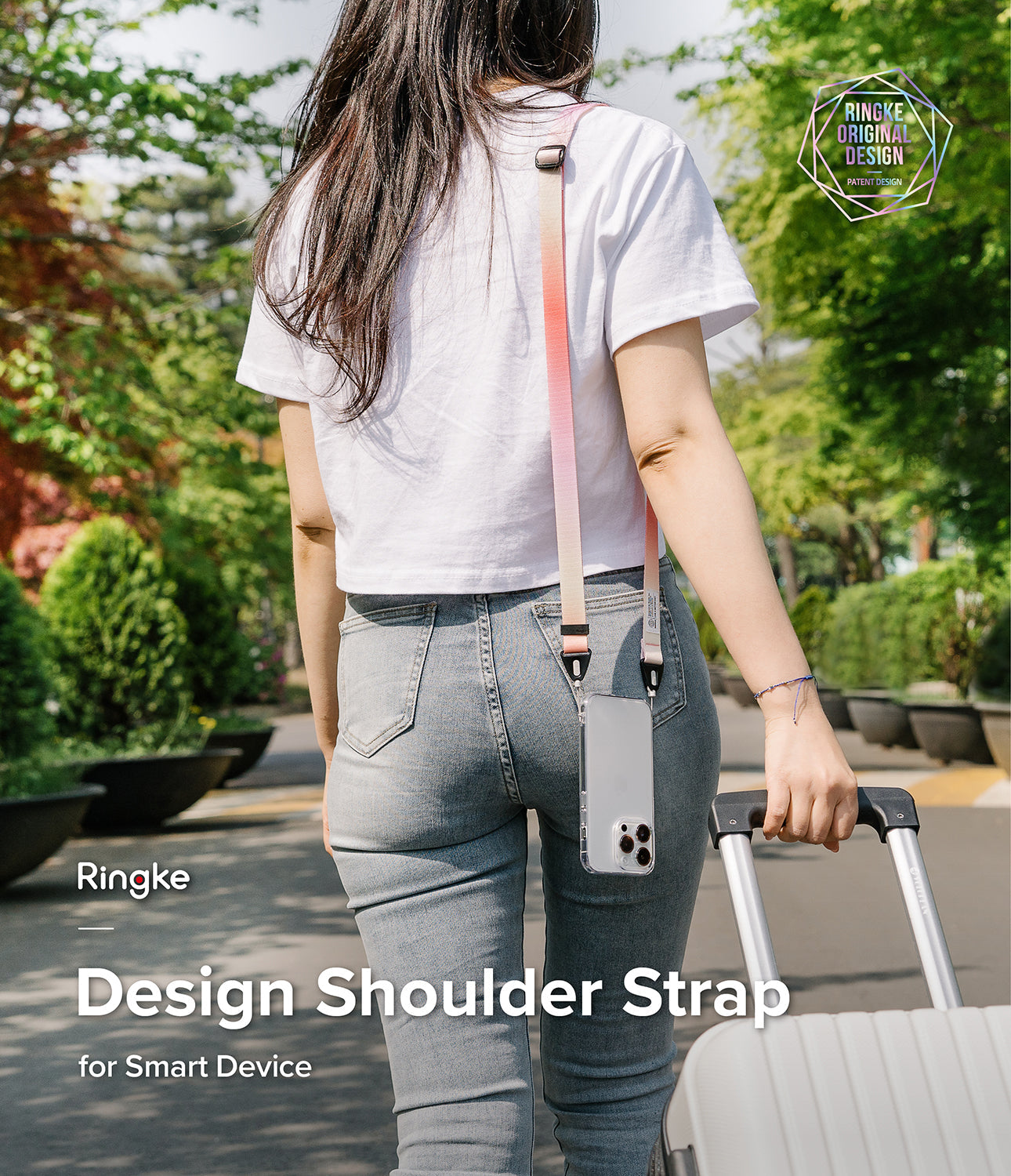 Design Shoulder Strap - Person wearing a pink-to-white gradient phone strap attached to a clear phone case while walking outdoors.