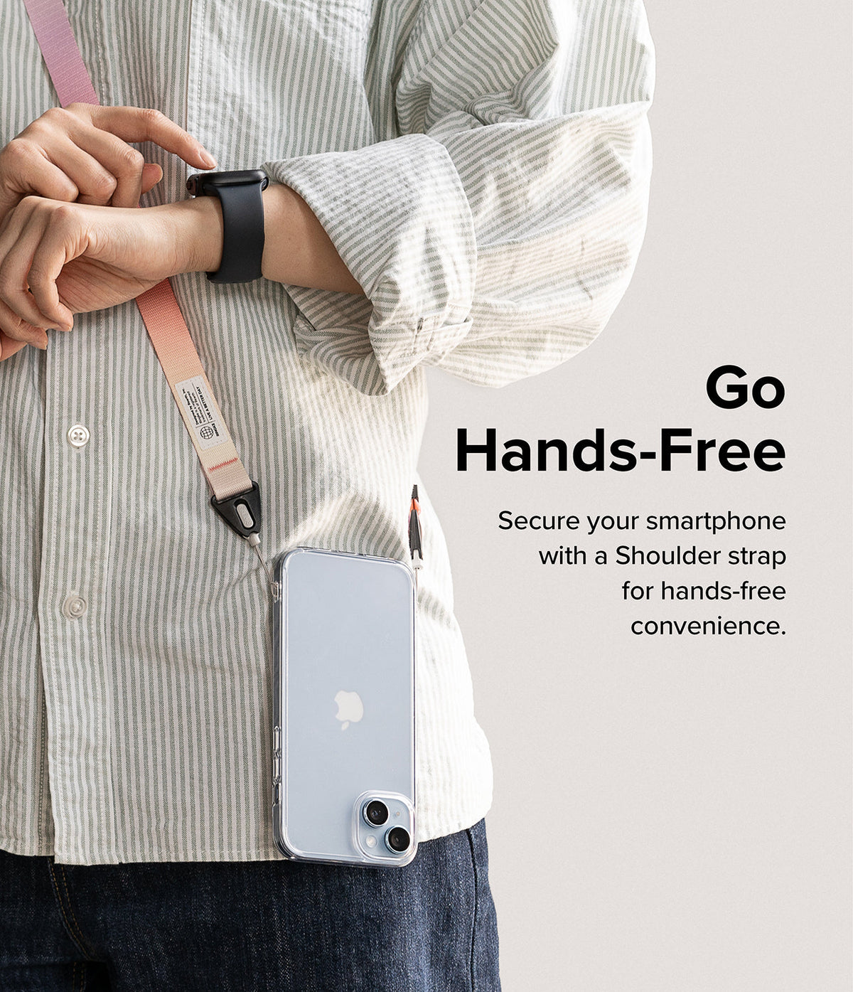 Design Shoulder Strap - Person wearing a pink and white crossbody phone strap attached to a clear smartphone case.