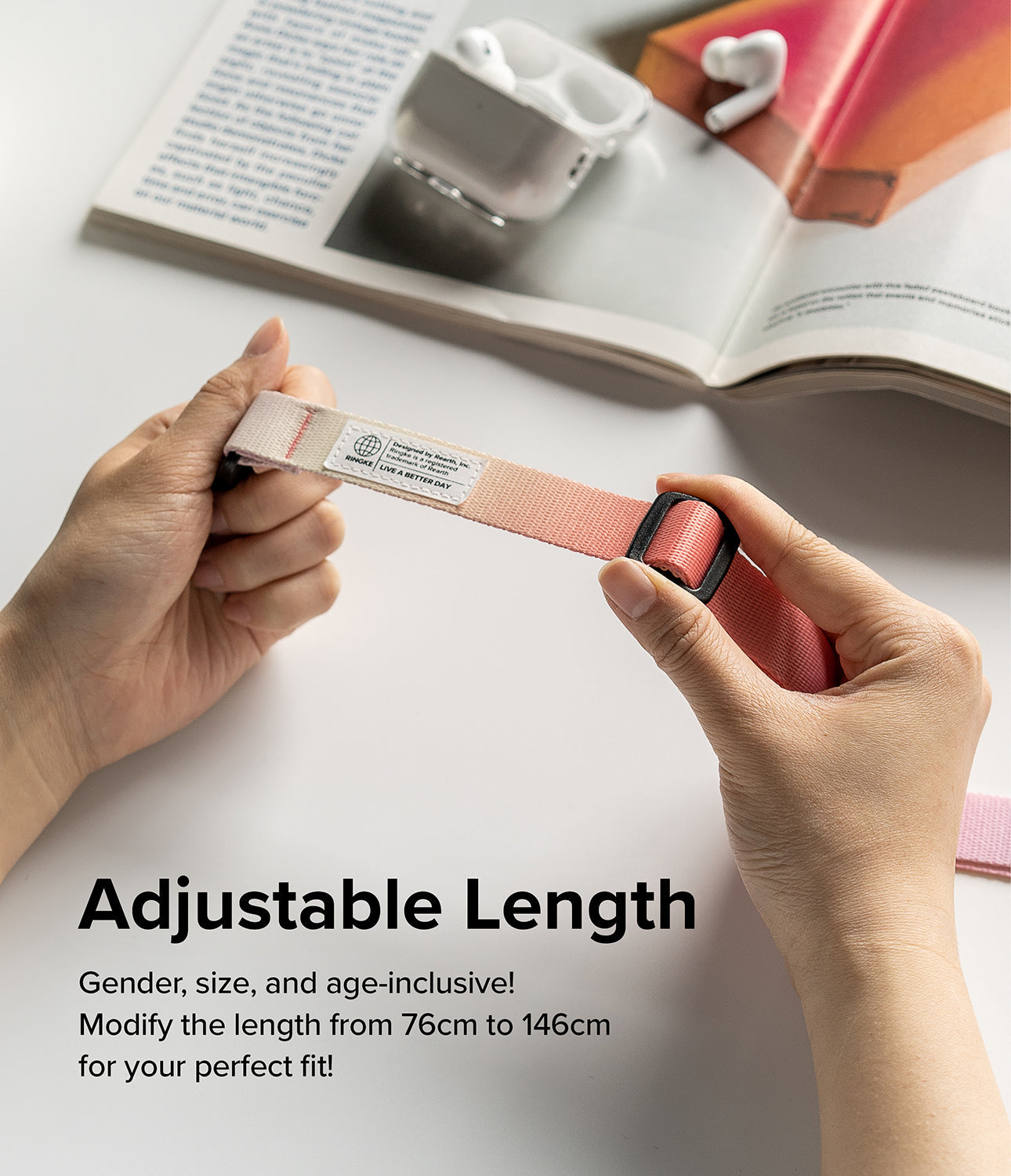 Design Shoulder Strap - Hands adjusting the length of a pink ombre woven strap with a black plastic buckle and logo tag.