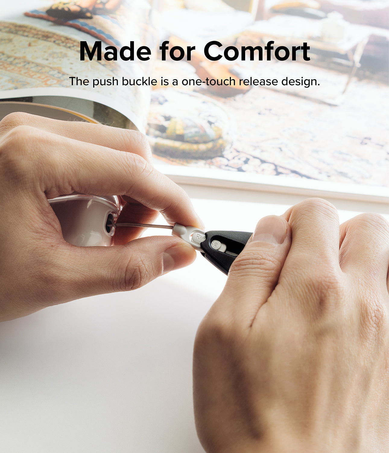 Design Shoulder Strap - Hands demonstrating the one-touch push buckle release mechanism on a shoulder strap connector.