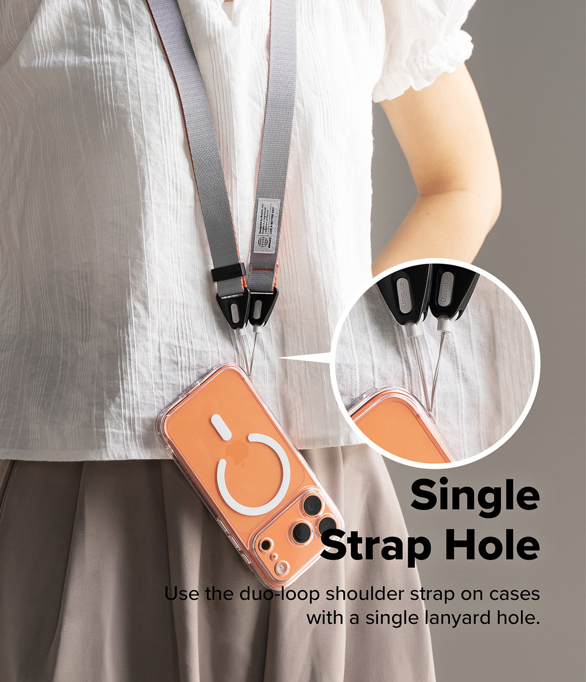 Design Shoulder Strap - A person wearing a grey and orange lanyard attached to a phone case with a single lanyard hole.