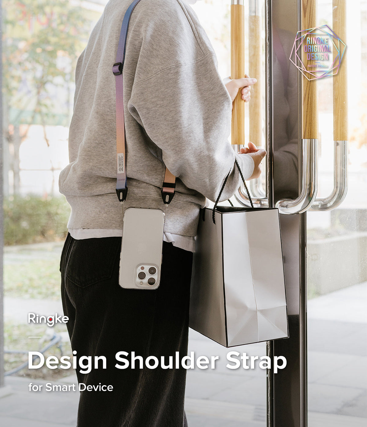 Design Shoulder Strap - Person wearing a colorful, adjustable crossbody strap attached to a smartphone case.
