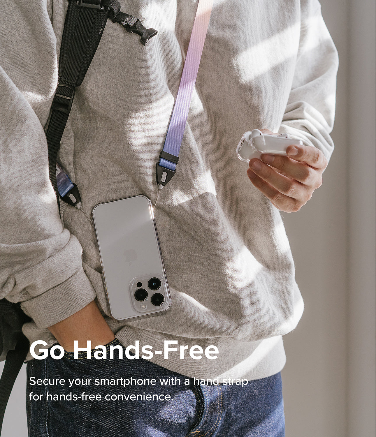 Design Shoulder Strap - A person wearing a pastel gradient shoulder strap attached to a clear smartphone case.