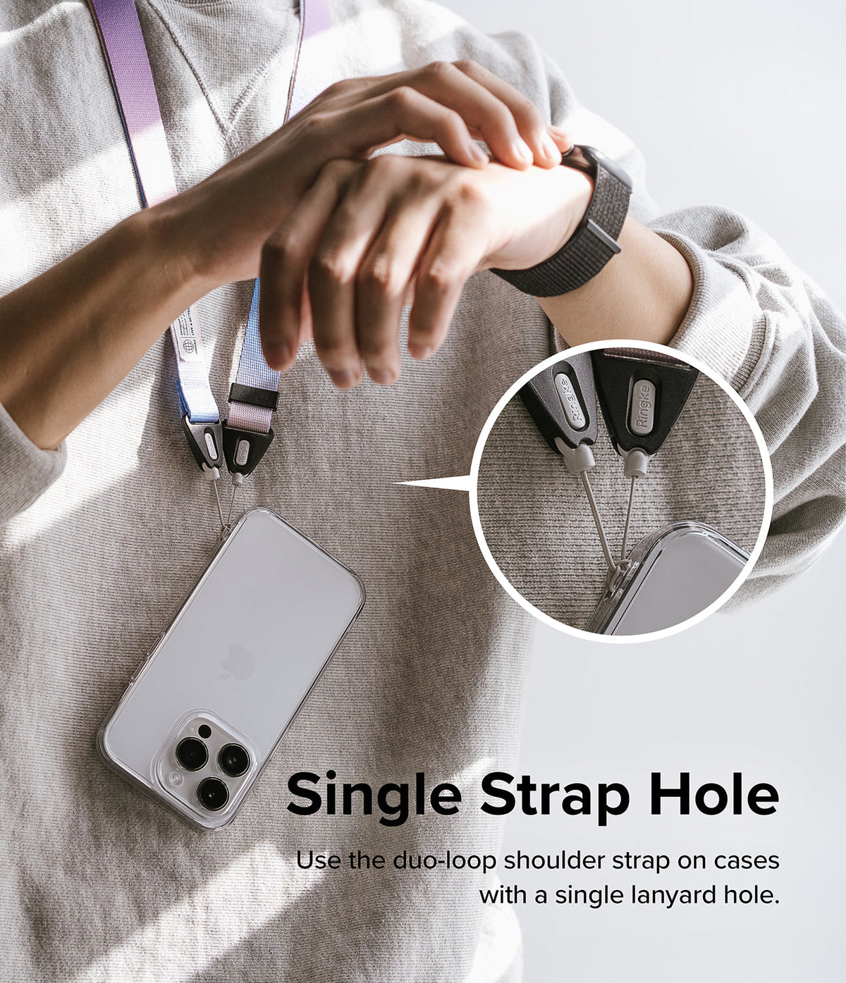 Design Shoulder Strap - A person wearing a multi-colored phone strap attached to a single lanyard hole on a clear phone case.