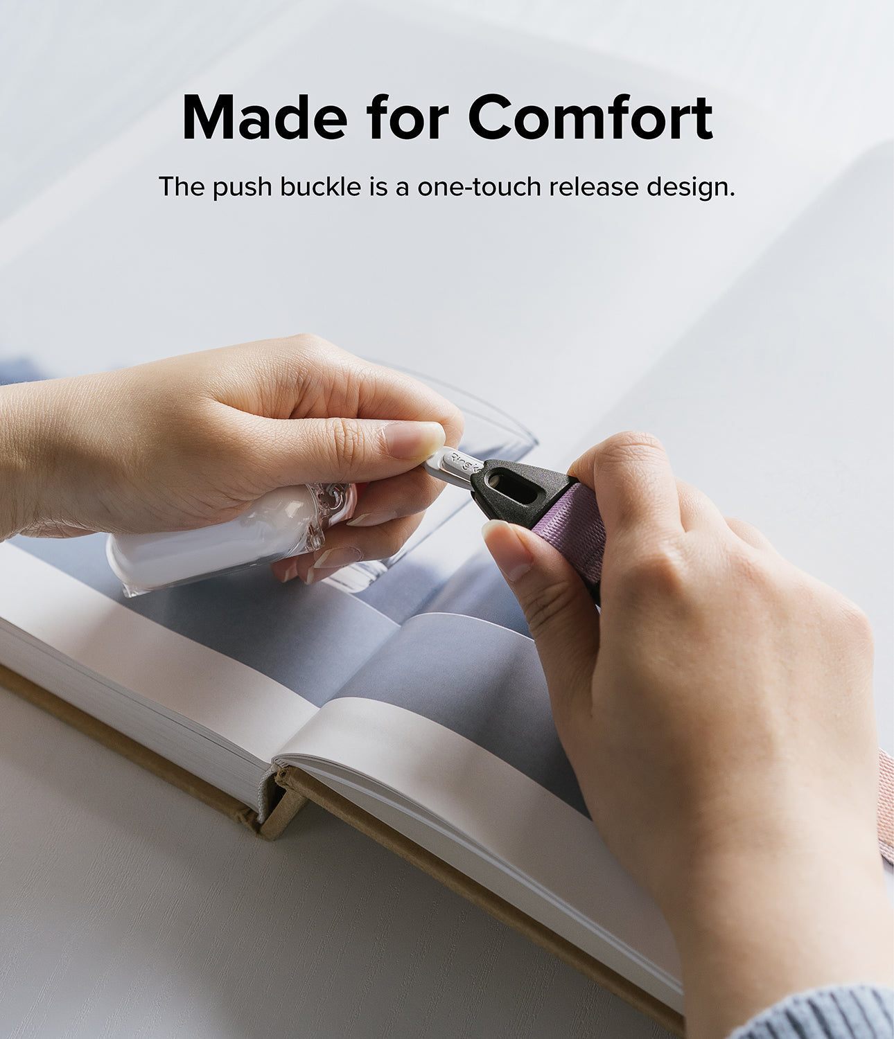 Design Shoulder Strap - Hands attaching a purple strap to a clear case using a one-touch push buckle mechanism.