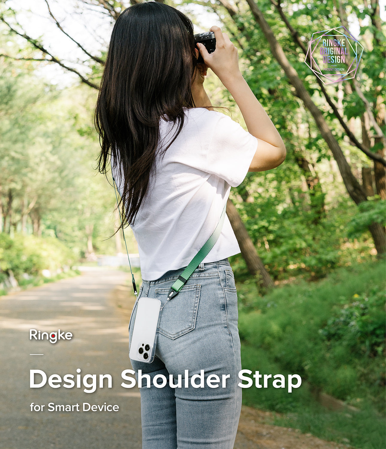 Design Shoulder Strap - Woman wearing a green phone shoulder strap with a clear case in a park setting.