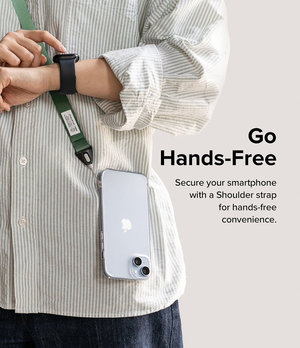 Design Shoulder Strap - A person wearing a green crossbody phone strap with a clear smartphone case attached.