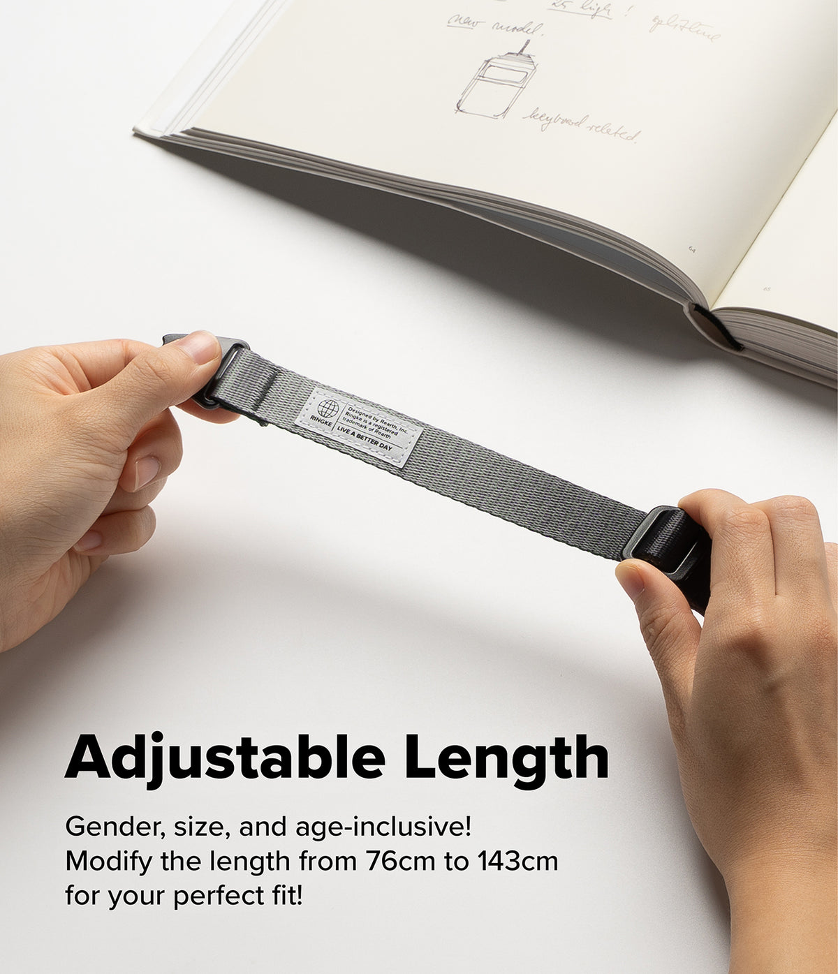 Design Shoulder Strap - Hands adjusting a grey fabric strap with a Ringke brand label and black plastic buckles.