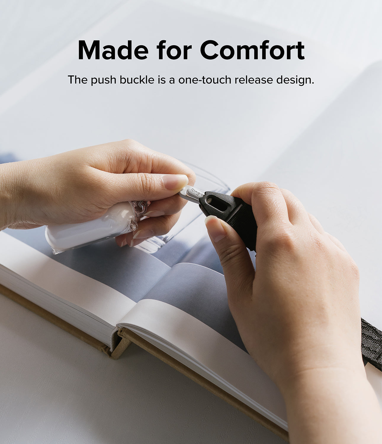 Design Shoulder Strap - Hands demonstrating the one-touch push buckle release mechanism of a black shoulder strap.