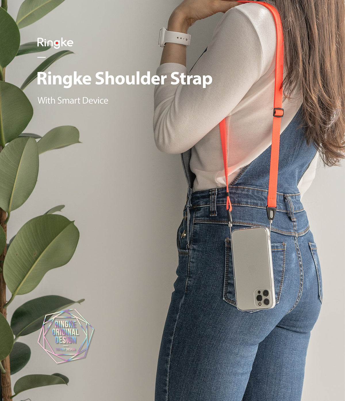 Shoulder Strap | Black / Neon Orange - Person wearing a neon orange crossbody phone strap attached to a clear phone case.