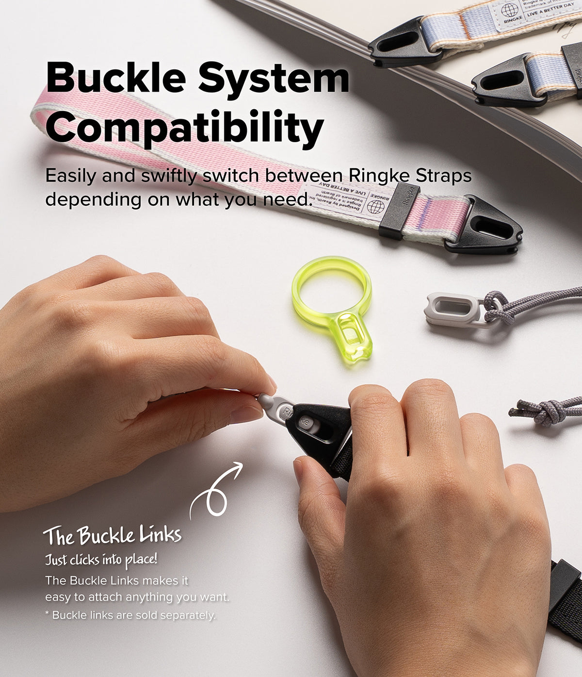 Design Shoulder Strap - A close-up of a person's hands demonstrating a buckle link adapter on a white background, with multiple Ringke straps and text reading 'Buckle System Compatibility' and 'Easily and swiftly switch between Ringke Straps depending on what you need.'.