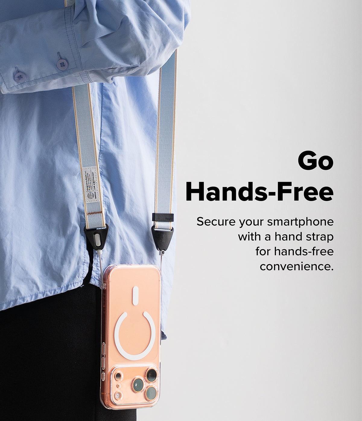 Design Shoulder Strap - A person wearing a light blue shirt with a phone on a light blue shoulder strap hanging at their side.