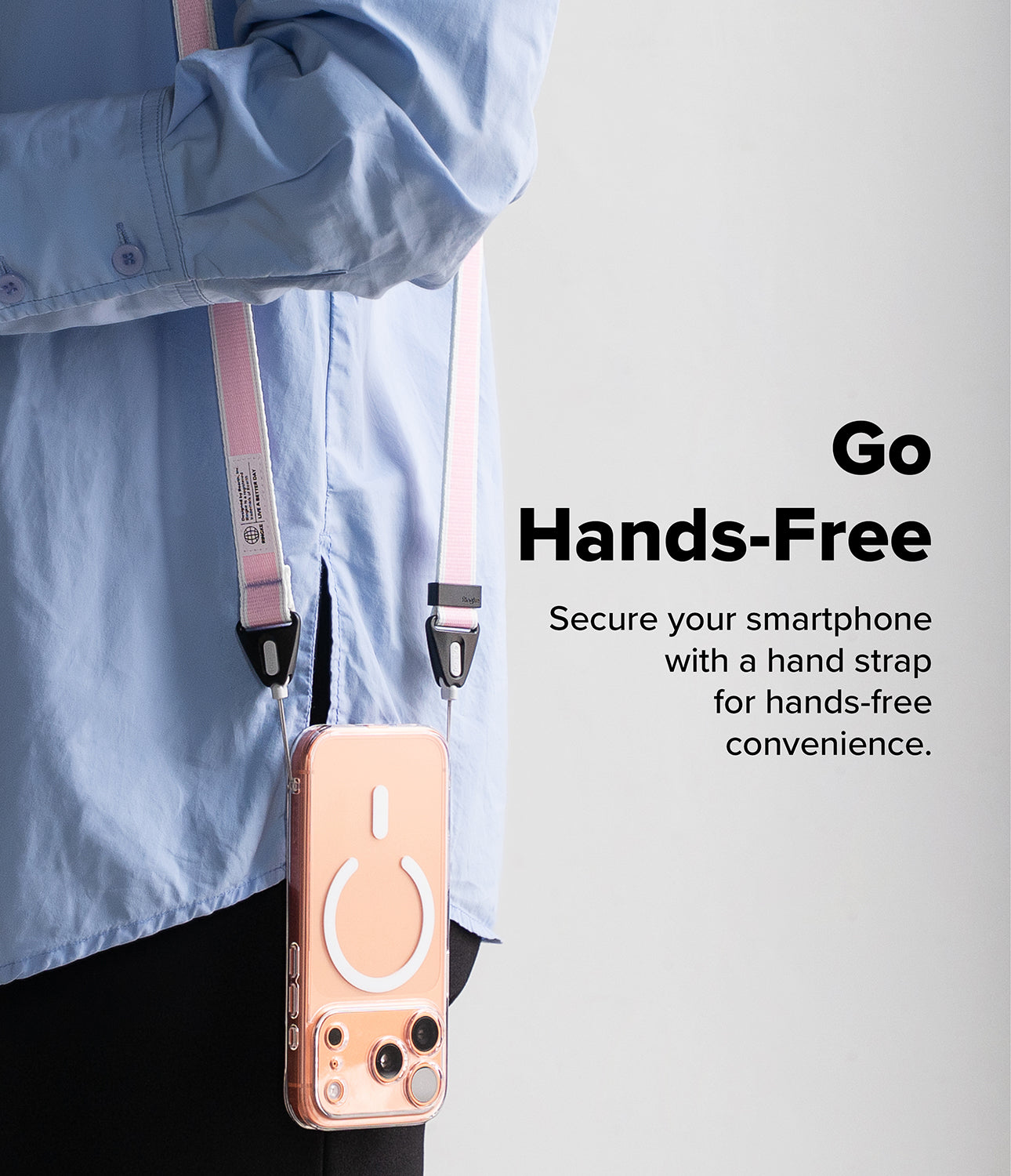 Design Shoulder Strap - A person wearing a pink and white phone shoulder strap attached to a clear smartphone case.