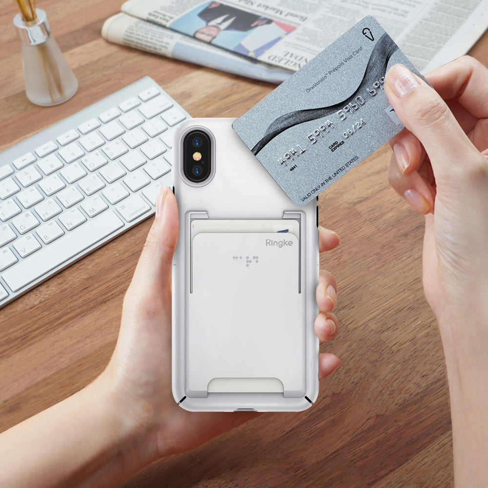 iPhone X Case | Slim + Slot Card Holder - Hands holding a white phone case with a built-in card slot, inserting a credit card.
