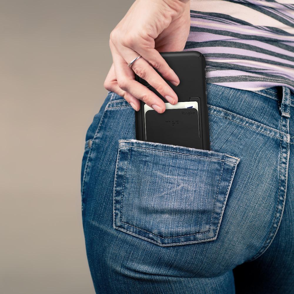 iPhone X Case | Slim + Slot Card Holder - Hand sliding a black phone case with a credit card slot into a back jeans pocket.