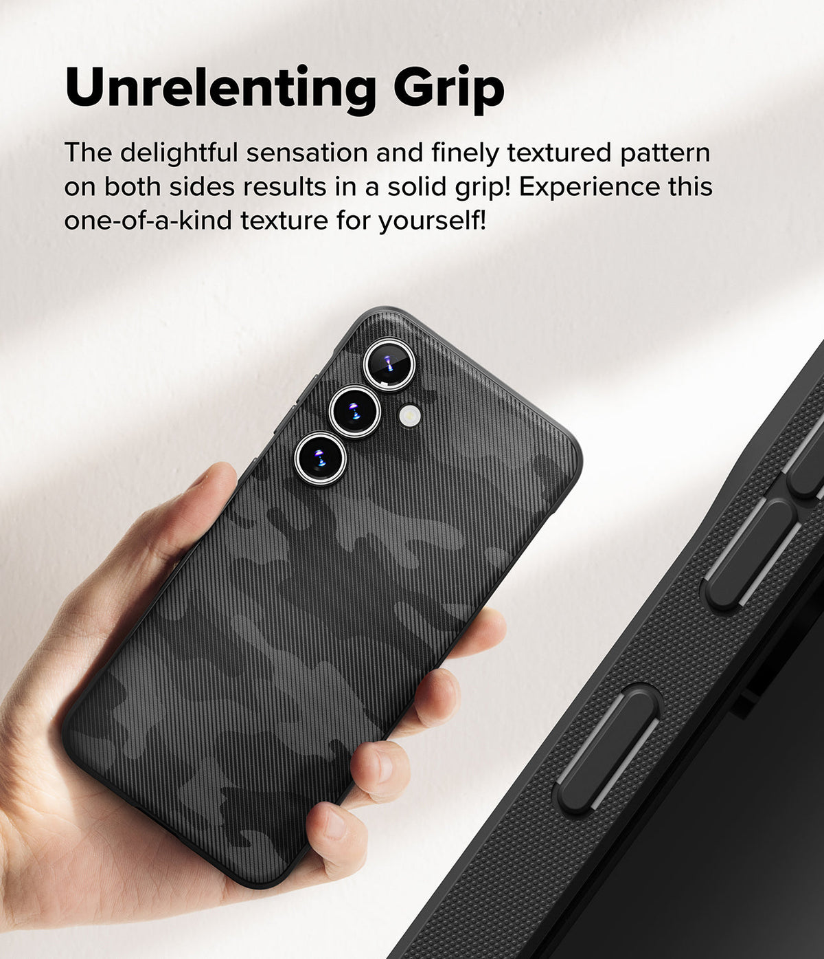Galaxy S24 FE Case | Onyx - Hand holding a black camo-patterned phone case with textured sides and triple camera lenses.
