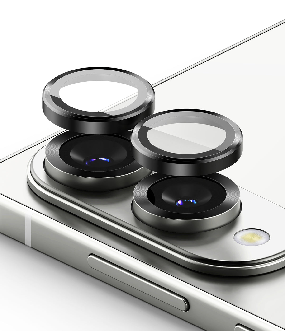 Galaxy S25 Edge | Camera Lens Frame Glass - Two black circular camera lens protectors hovering above the rear lenses of a silver smartphone.