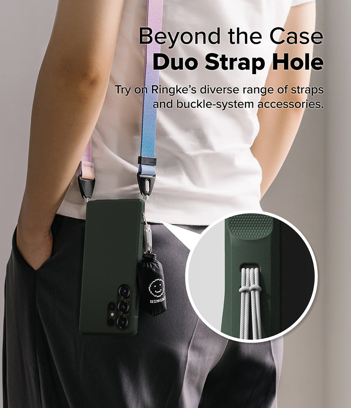 Galaxy S25 Ultra Case | Onyx - Person wearing a green phone case with a colorful crossbody strap and a small smiley charm.
