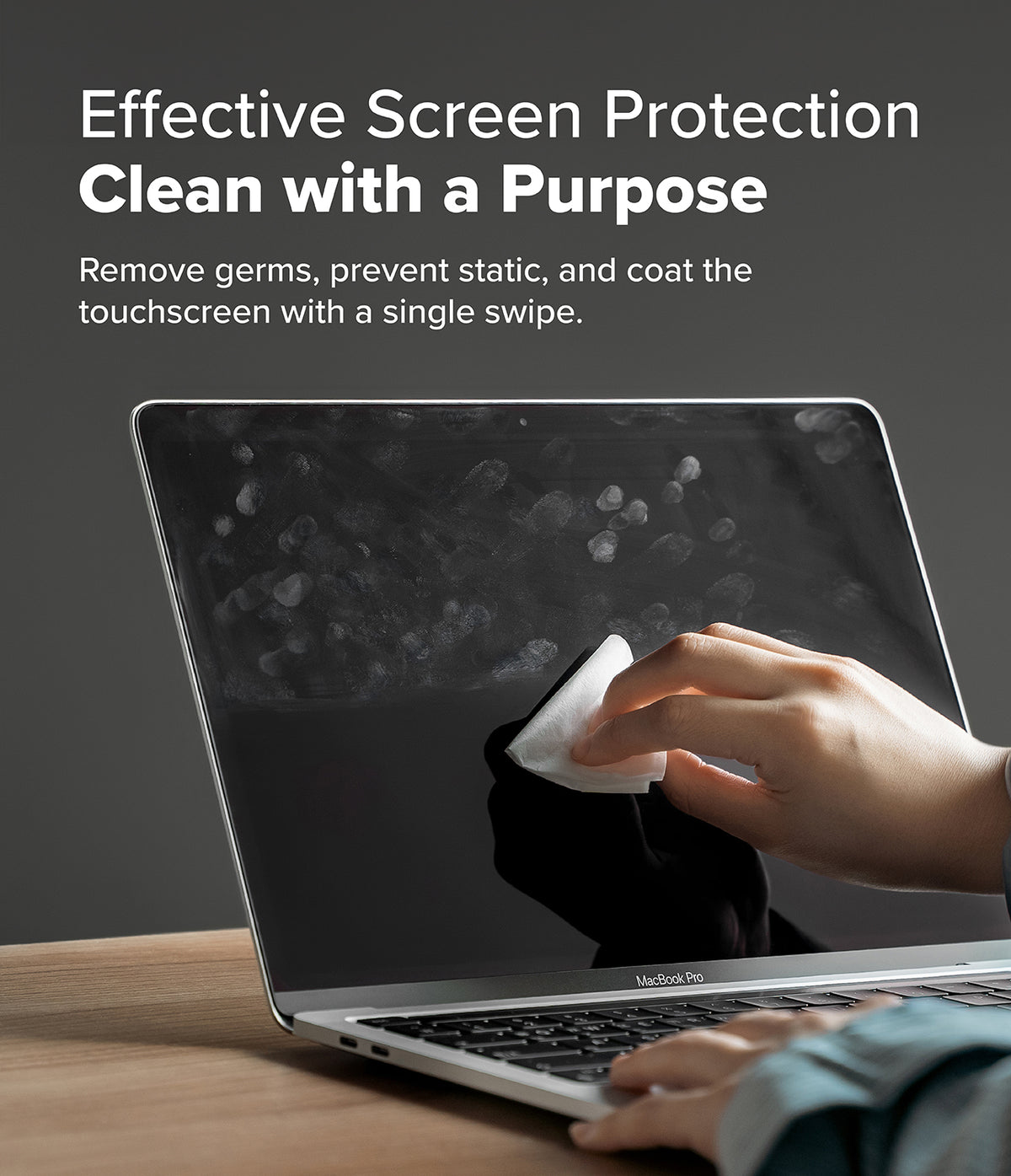 Screen and Lens Cleaning Wipes - Hand using a wipe to clean fingerprints off a smudged MacBook Pro screen.