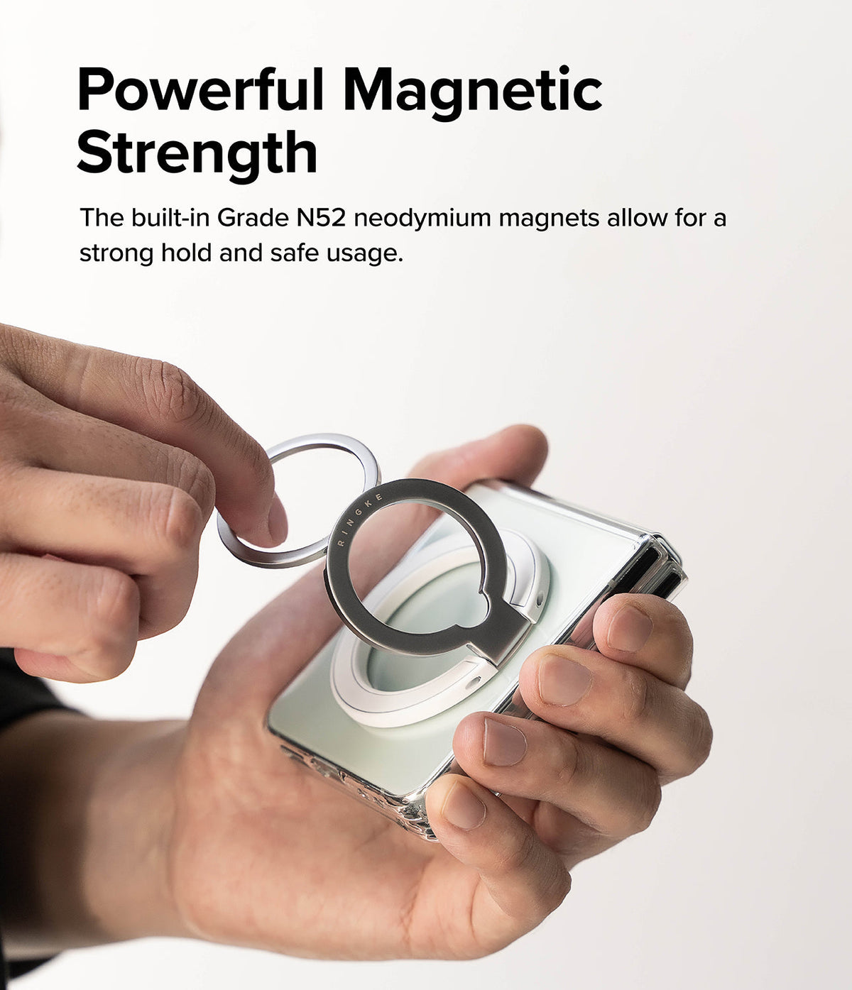 Ringke Smart Ring Magnetic - Hands attaching a magnetic ring accessory to a foldable smartphone case.