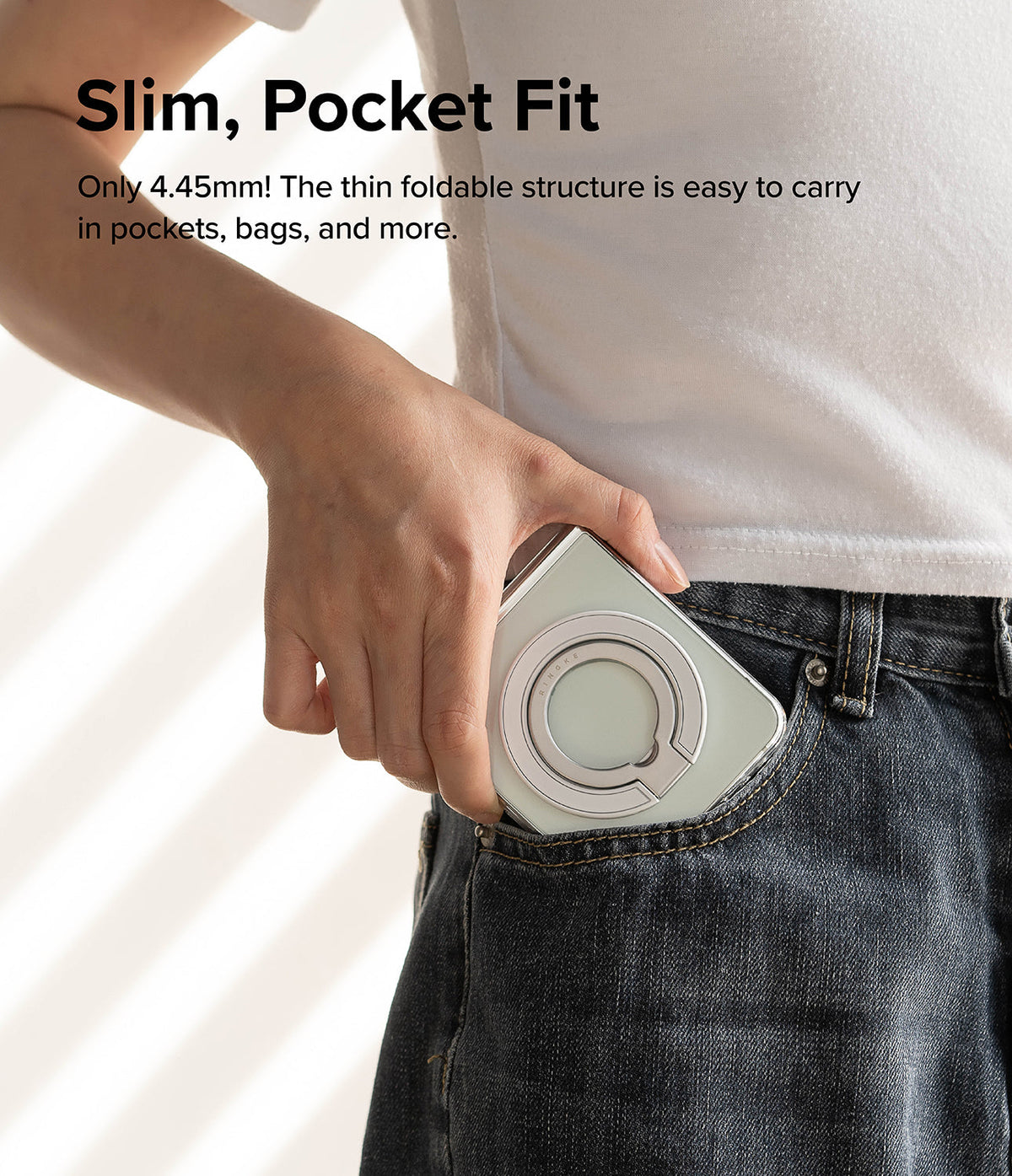 Ringke Smart Ring Magnetic - A person sliding a phone with a slim magnetic ring holder into their jeans pocket.