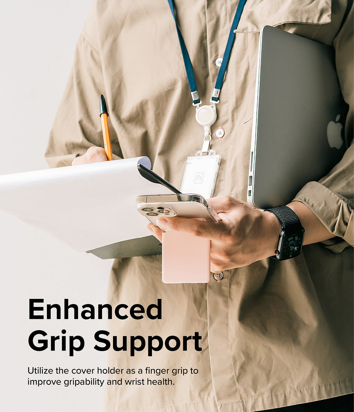 Card Holder | Stand Slot - Person holding a phone with a pink magnetic card holder acting as a finger grip while carrying a laptop.