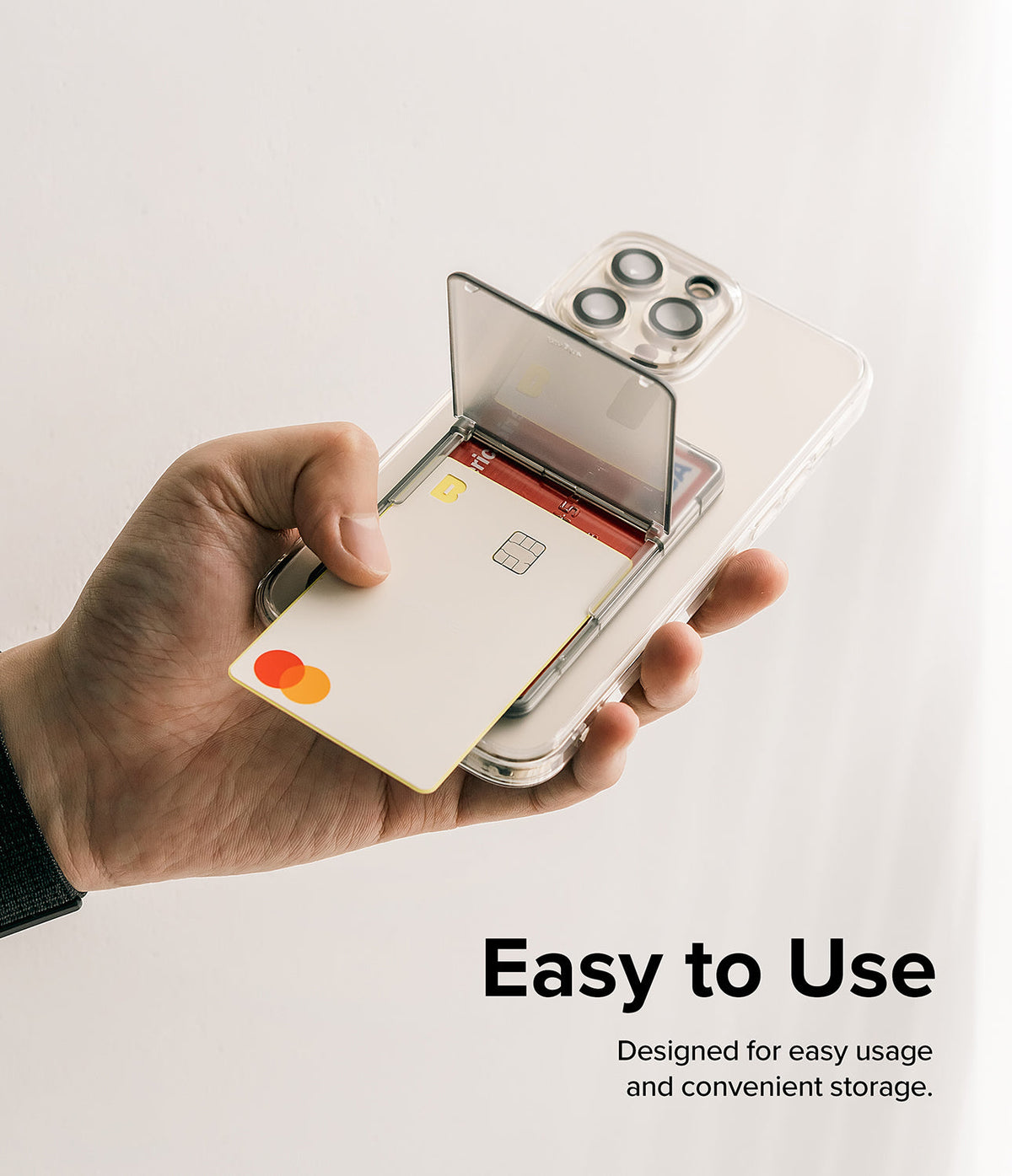 Card Holder | Stand Slot - Hand holding a clear phone case with a flip-out card slot containing two credit cards.