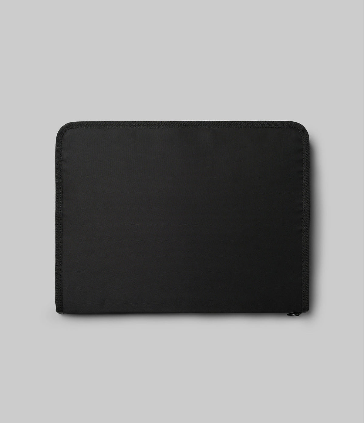 Pad Pouch | Smart Zip Pouch - A minimalist, rectangular black zippered pouch centered on a light gray background.