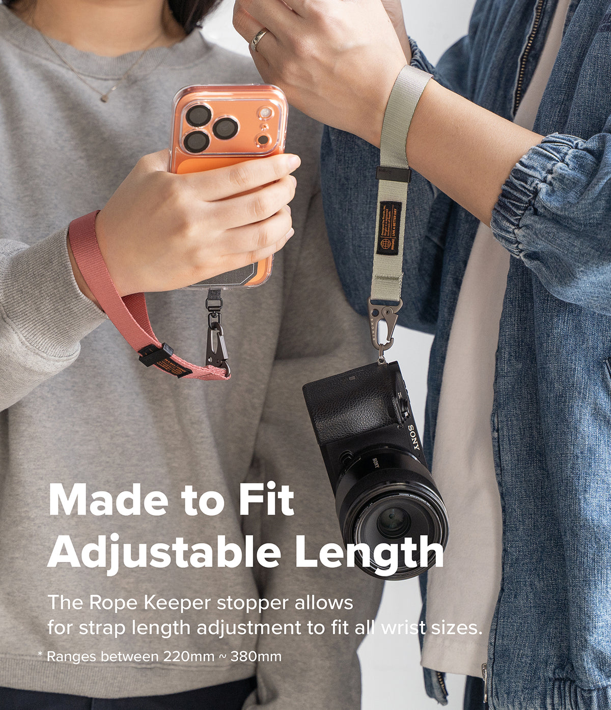 Holder Link Tactical Webbing Hand Strap - Two people wearing adjustable webbing straps attached to a phone and camera.