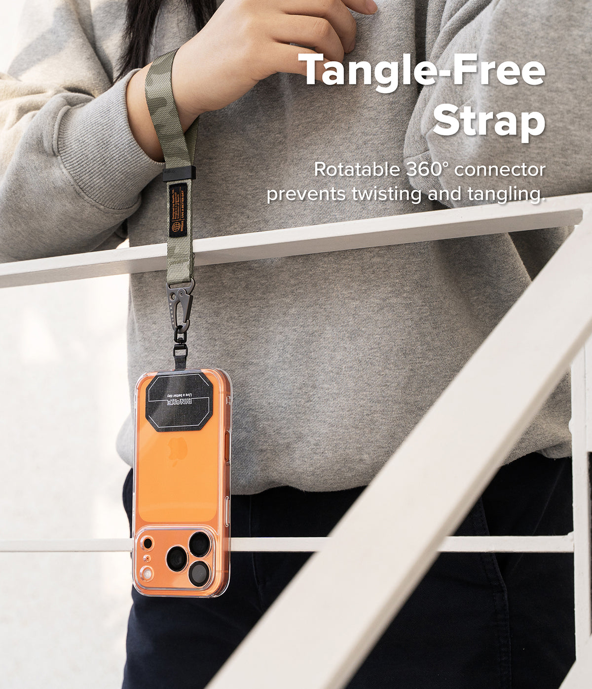 Holder Link Tactical Webbing Hand Strap - Olive green tactical wrist strap attached to an orange phone case via a 360° swivel.