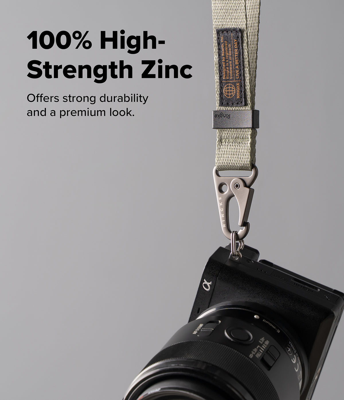 Holder Link Tactical Webbing Hand Strap - Beige tactical strap with a zinc alloy carabiner attached to a black camera.