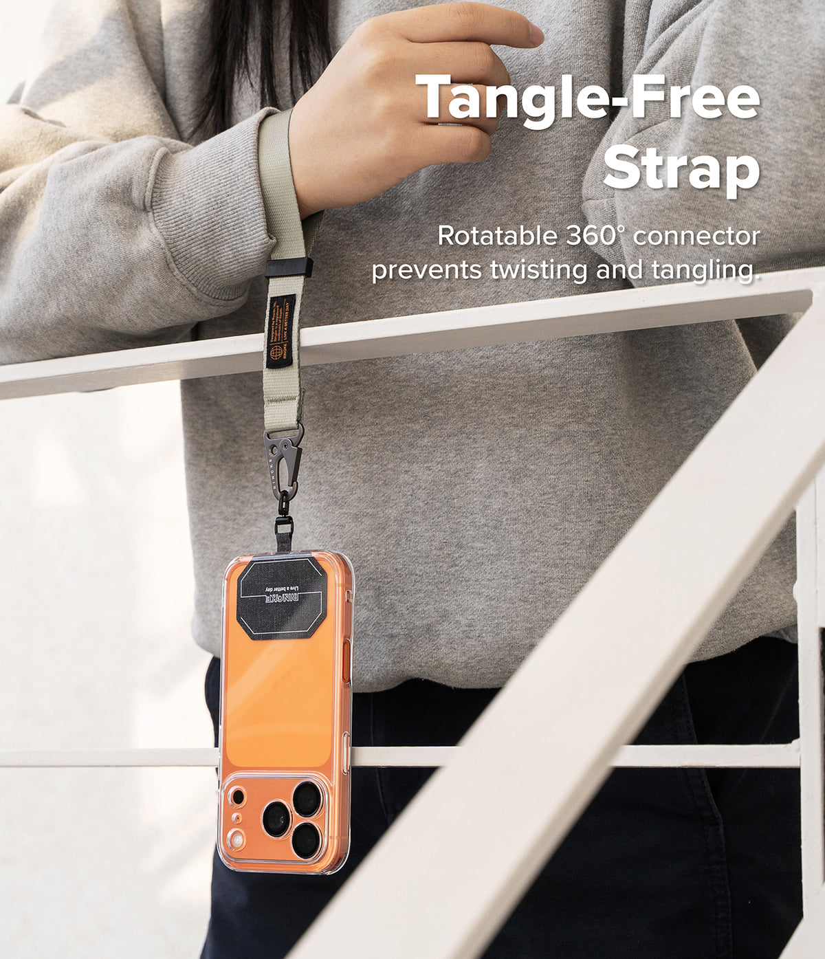 Holder Link Tactical Webbing Hand Strap - Person wearing a gray tactical wrist strap attached to a phone case.
