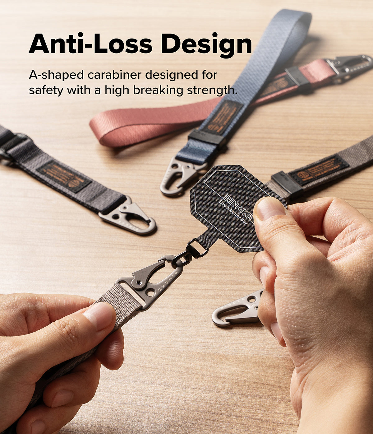 Holder Link Tactical Webbing Lanyard Strap - Close-up of a person holding a black carabiner attached to a webbing strap, with other straps and a text overlay reading 'Anti-Loss Design' on a light wood surface.