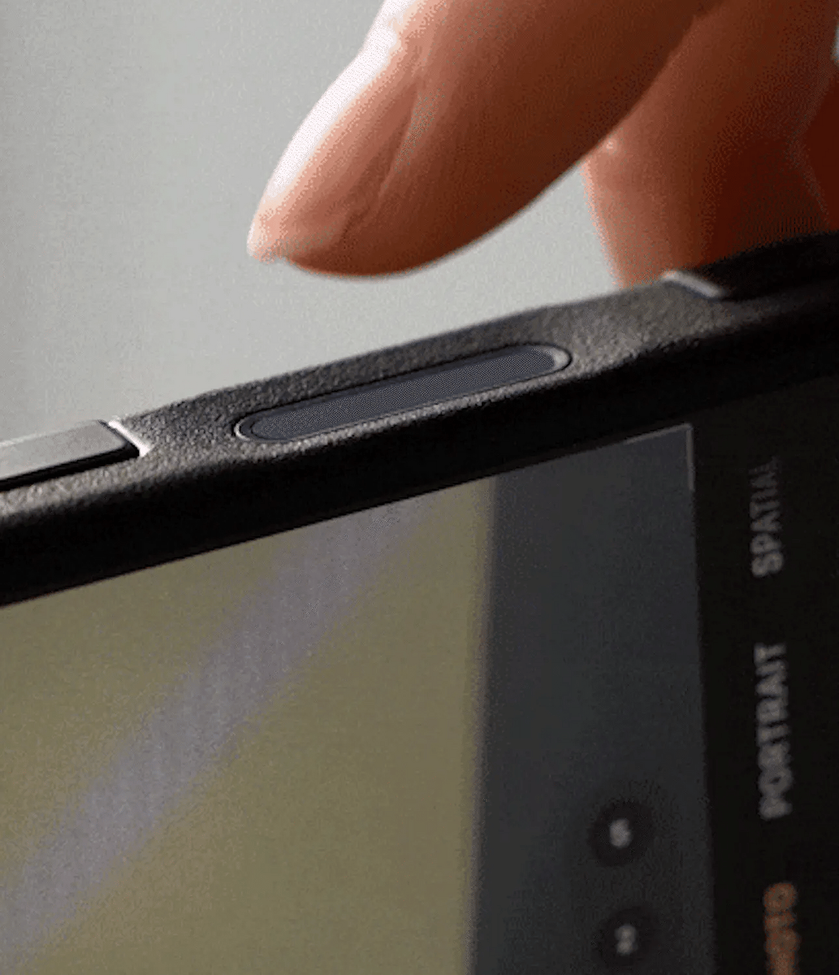iPhone 16 Pro Case | Alles - A finger presses the Camera Control button on a textured black iPhone 16 Pro case.
