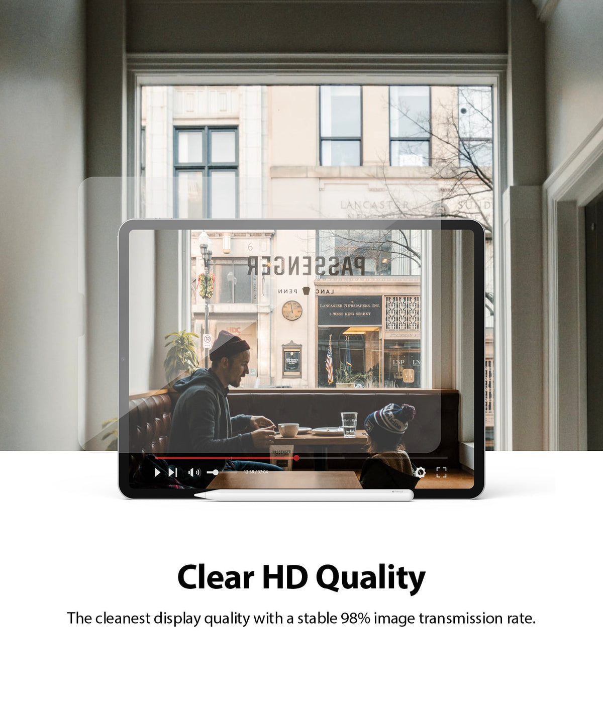 Invisible Defender Glass | iPad - Transparent screen protector over an iPad displaying a clear video of a cafe scene.