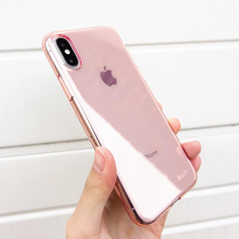 iPhone X Case | Air - A hand holding a rose gold iPhone X in a clear, slim protective case against a white slatted background.