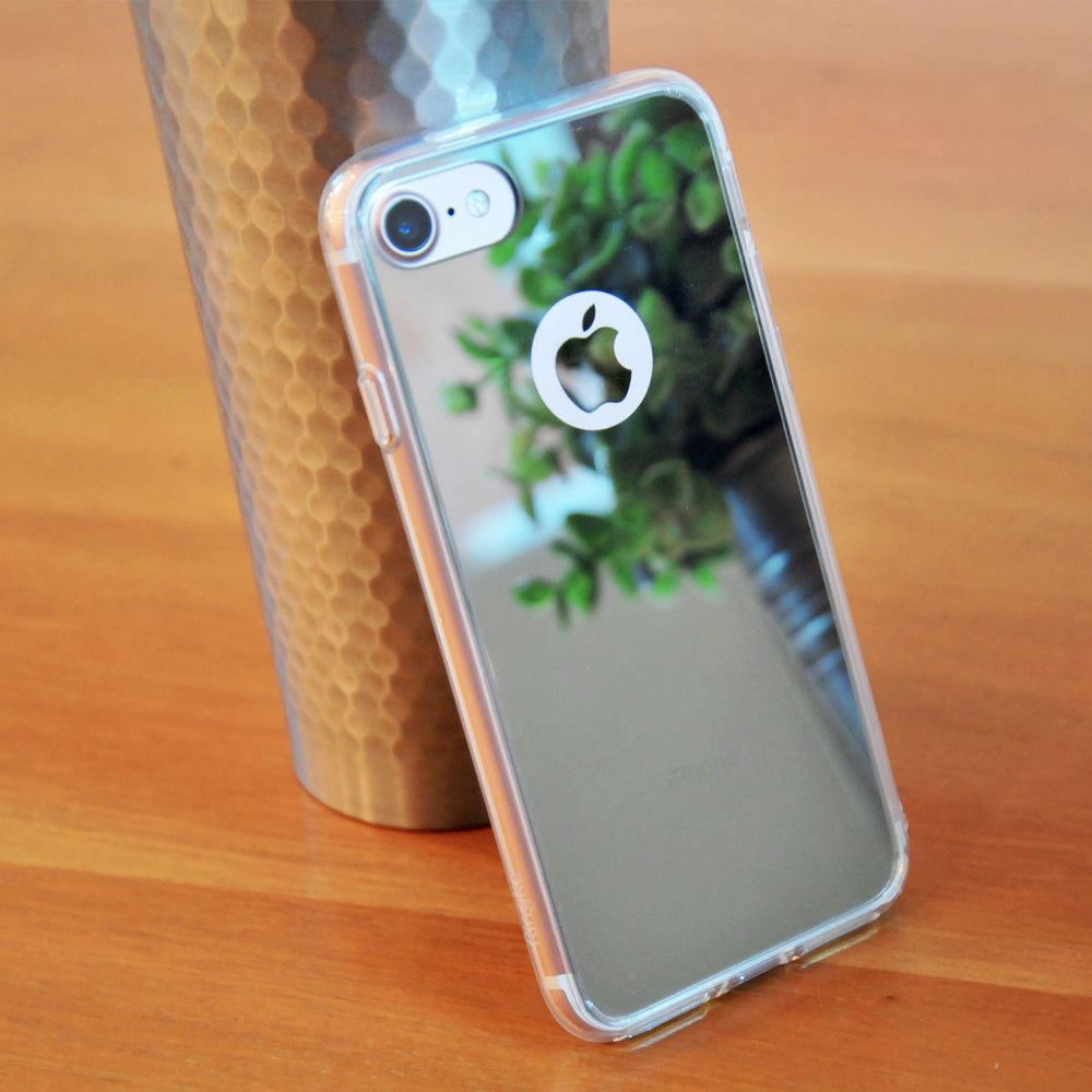 iPhone 7 Case | Mirror - Reflective phone case leaning against a textured metal cup on a wooden surface.