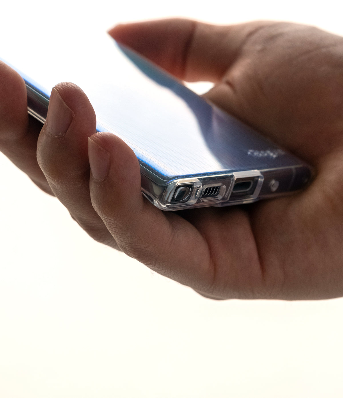 Galaxy Note 10 Case | Air - Clear (Dot) - Hand holding a clear phone case with a dotted pattern, showing bottom ports.