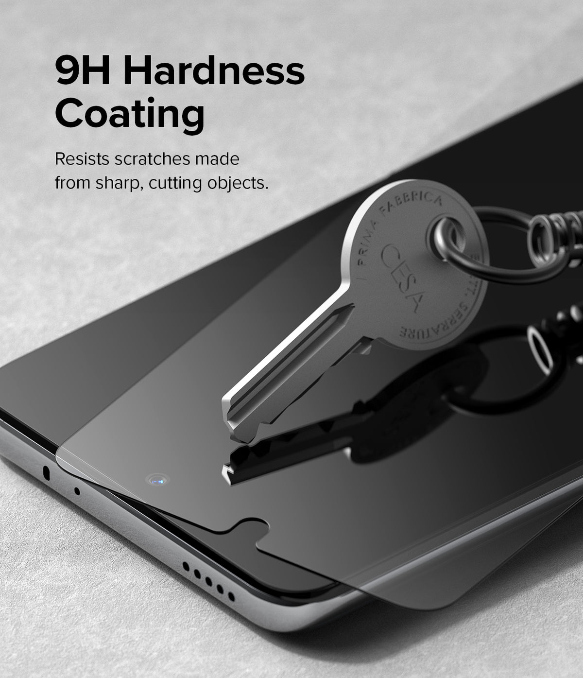 Xiaomi 12T / 12T Pro Screen Protector | Full Cover Glass - Xiaomi 12T / 12T Pro Screen Protector - A metal key pressing against a smartphone screen protector to show scratch resistance.
