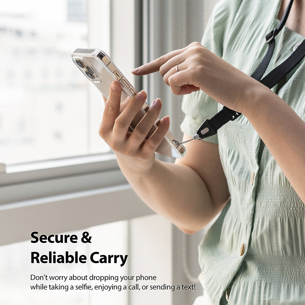 Lanyard Strap | Black - Person wearing a black phone lanyard while holding a smartphone in a clear case.